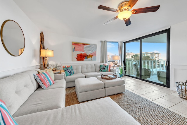 tiled living room with a wall of windows and ceiling fan