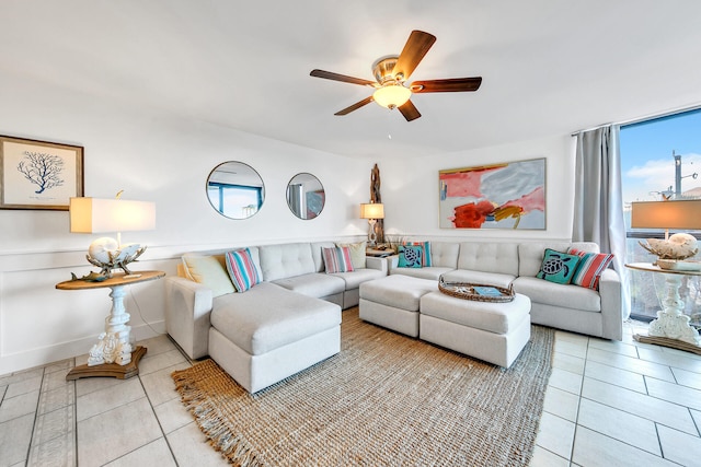 tiled living room with ceiling fan