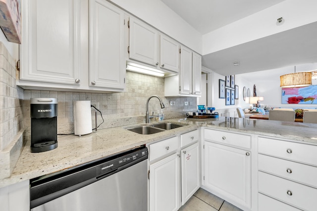 kitchen featuring dishwasher, decorative backsplash, white cabinets, sink, and light stone countertops