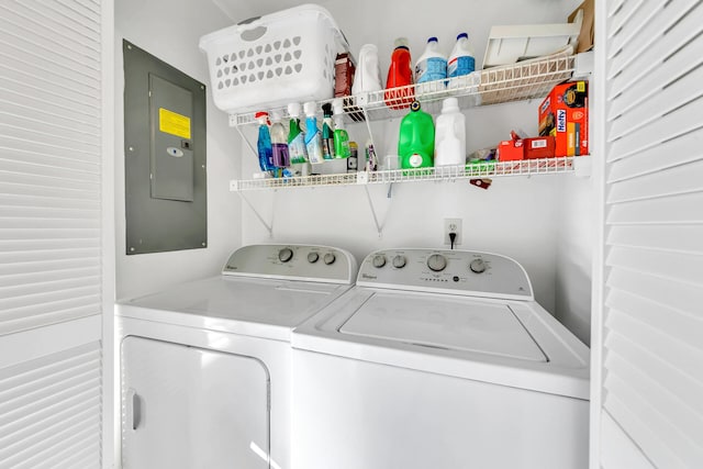 clothes washing area with washer and clothes dryer and electric panel