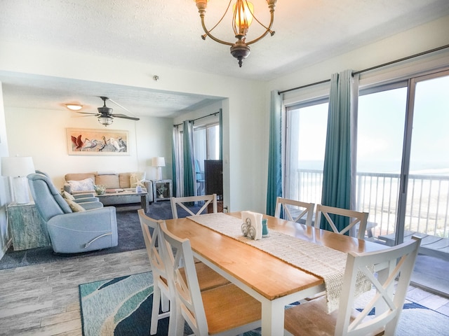 790 Santa Rosa Blvd Unit 706, Fort Walton Beach, FL 32548 - dining area featuring wood-type flooring, a textured ceiling, and ceiling fan with notable chandelier
