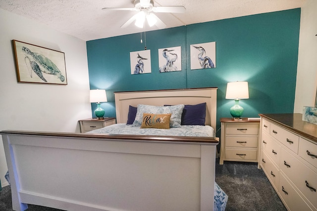 bedroom with ceiling fan, a textured ceiling, and dark carpet