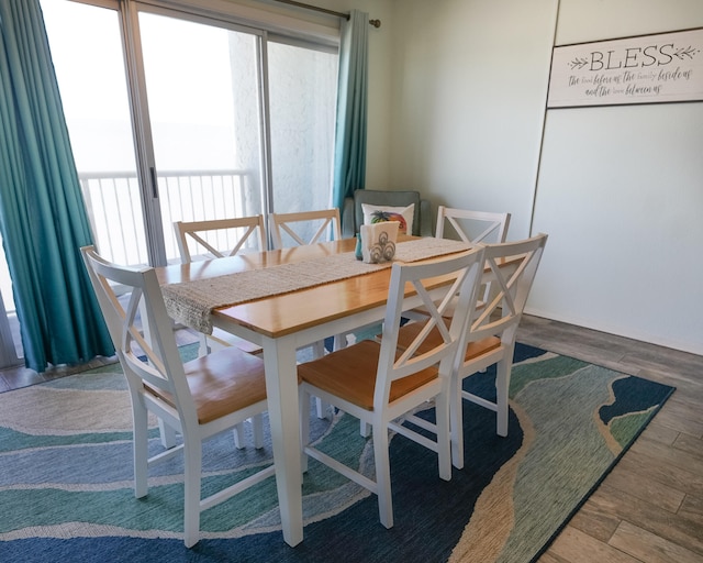 dining space with wood-type flooring