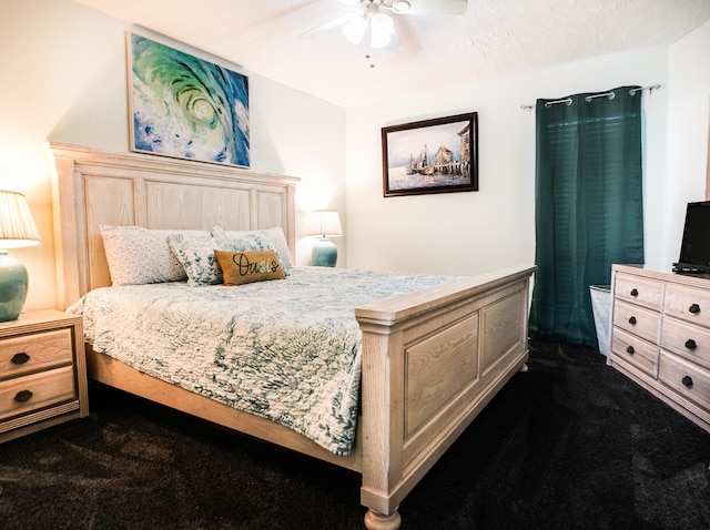 carpeted bedroom with a textured ceiling and ceiling fan