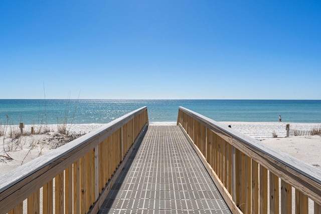 surrounding community featuring a view of the beach and a water view