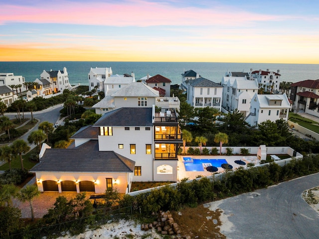 aerial view at dusk with a water view