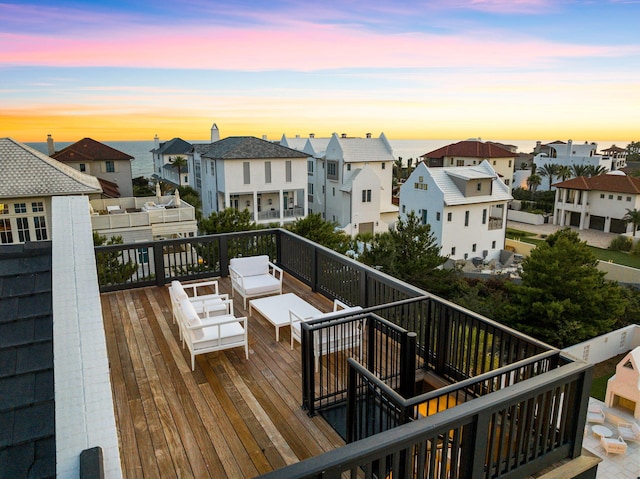 deck at dusk featuring an outdoor hangout area