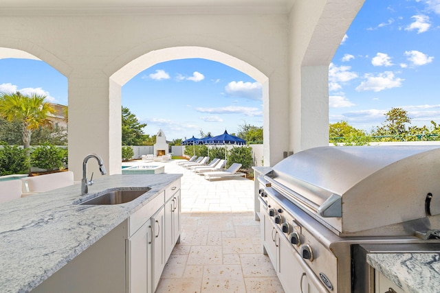 view of patio / terrace with area for grilling and sink