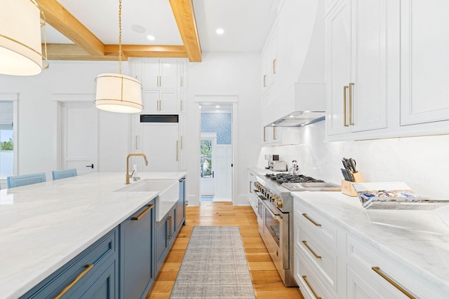 48 Paradise By The Sea Blvd, Inlet Beach, FL 32461 - kitchen with stainless steel range, blue cabinetry, a sink, white cabinets, and beam ceiling