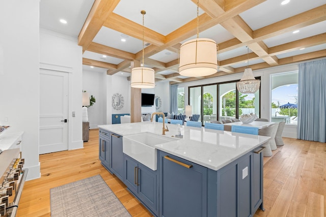 kitchen with light hardwood / wood-style flooring, hanging light fixtures, coffered ceiling, and plenty of natural light