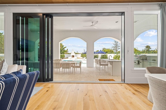 doorway featuring hardwood / wood-style floors and ceiling fan