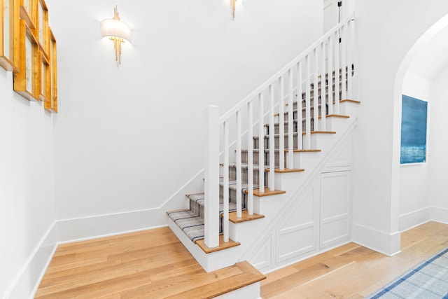 48 Paradise By The Sea Blvd, Inlet Beach, FL 32461 - stairs featuring wood finished floors, arched walkways, and baseboards