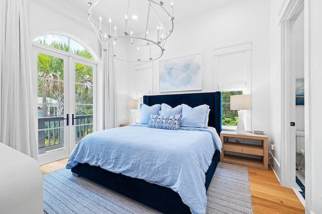 bedroom featuring french doors, hardwood / wood-style floors, ornamental molding, and multiple windows