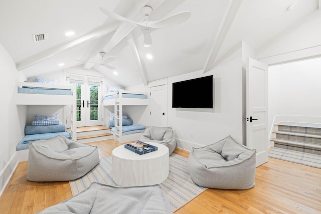 living room with ceiling fan, wood-type flooring, vaulted ceiling with beams, and french doors