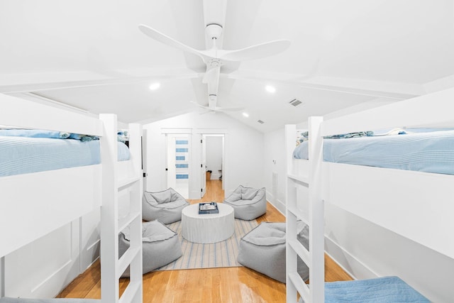 bedroom featuring hardwood / wood-style flooring, ceiling fan, and vaulted ceiling