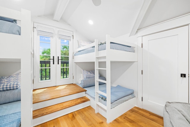 bedroom with hardwood / wood-style floors, vaulted ceiling with beams, french doors, and access to outside