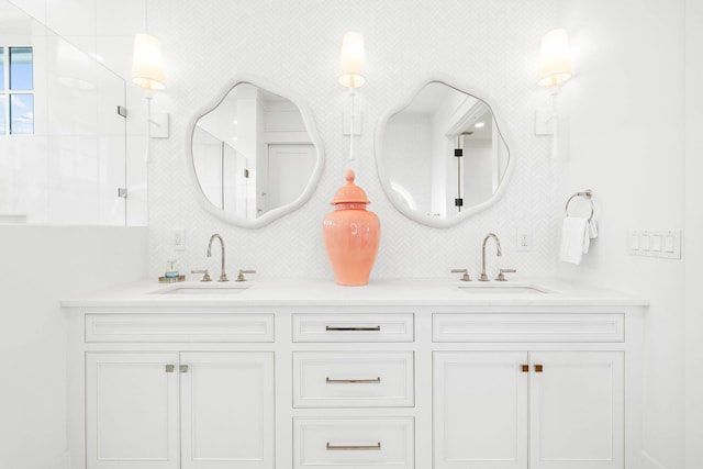 bathroom featuring a shower and vanity