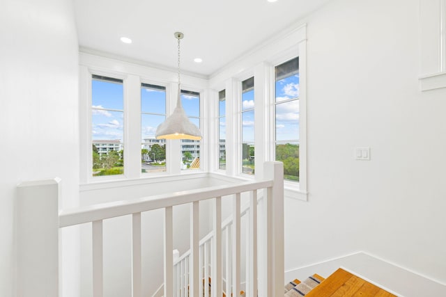 corridor with hardwood / wood-style floors