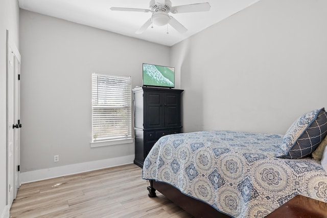 bedroom with light hardwood / wood-style floors and ceiling fan