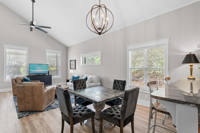 182 Pisces Dr, Santa Rosa Beach, FL 32459 - dining room with lofted ceiling, light wood finished floors, a chandelier, and a ceiling fan