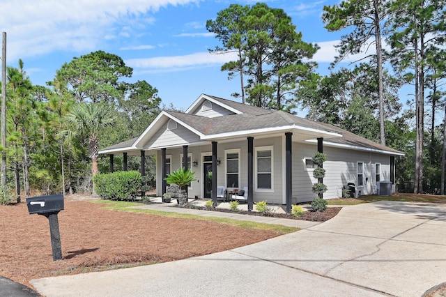 view of front of property with cooling unit and covered porch