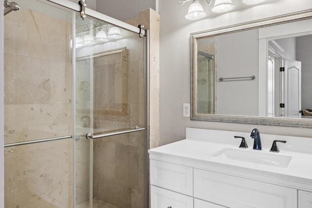 bathroom with walk in shower and vanity