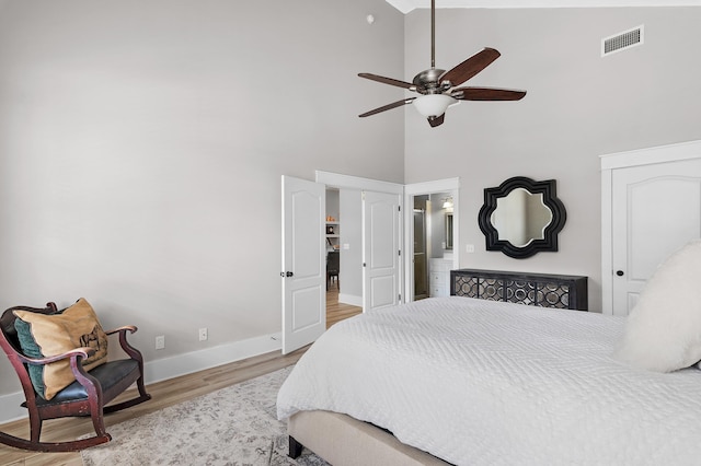 bedroom with high vaulted ceiling, wood-type flooring, and ceiling fan