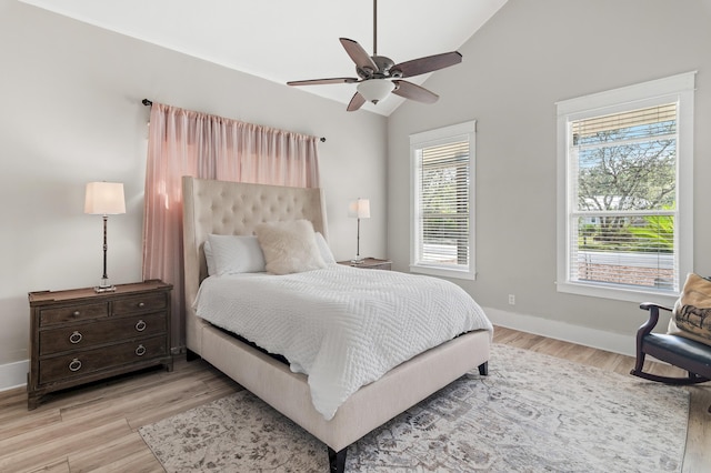 bedroom with light wood-type flooring, lofted ceiling, and ceiling fan