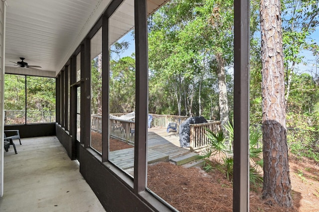 unfurnished sunroom with ceiling fan