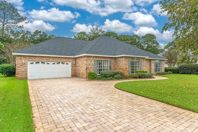 view of front of house with a garage and a front lawn