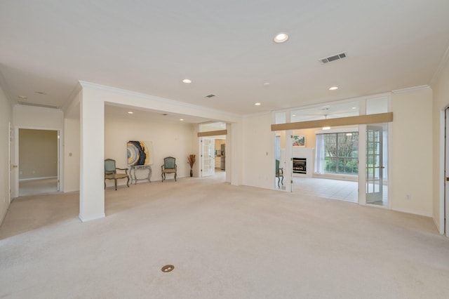 living room with light colored carpet and ornamental molding