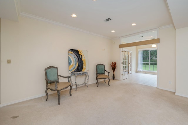 living area featuring light carpet and crown molding