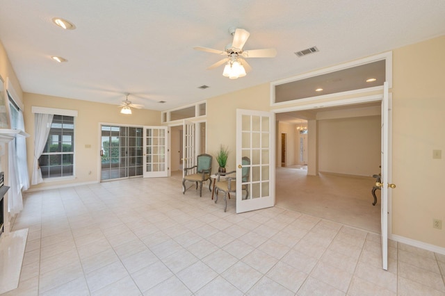 unfurnished room featuring ceiling fan, french doors, and light tile patterned flooring