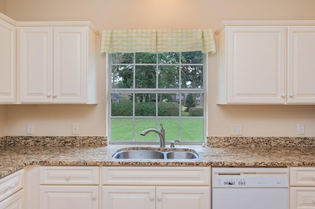 kitchen with dishwasher, white cabinetry, and sink