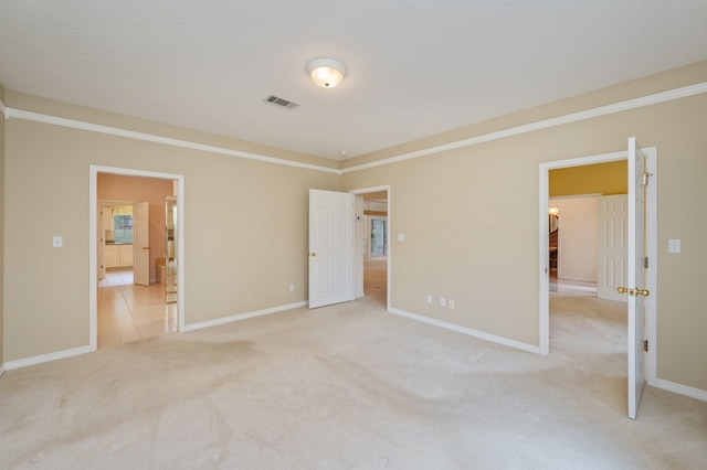 interior space featuring a textured ceiling and crown molding