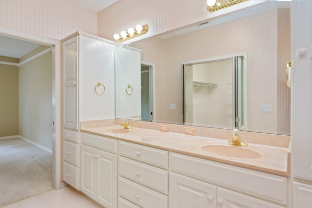 bathroom with tile patterned flooring and vanity