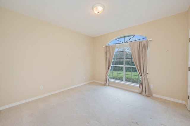 spare room featuring light colored carpet