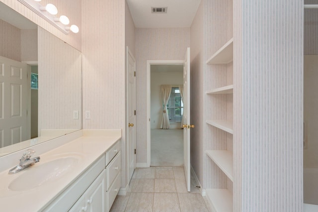 bathroom featuring tile patterned flooring and vanity