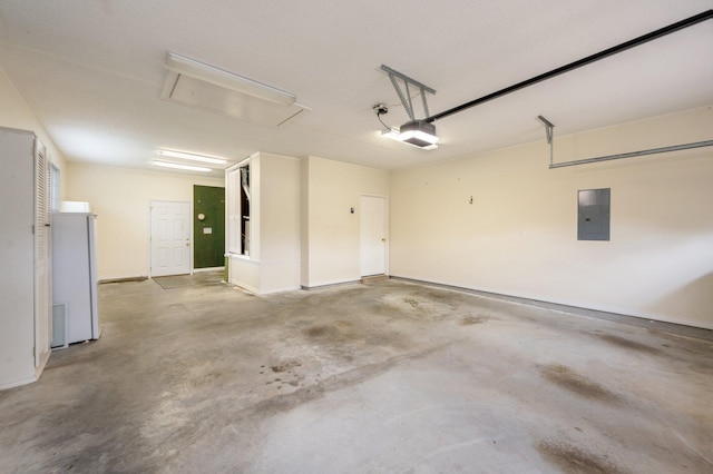 garage with white refrigerator, a garage door opener, and electric panel