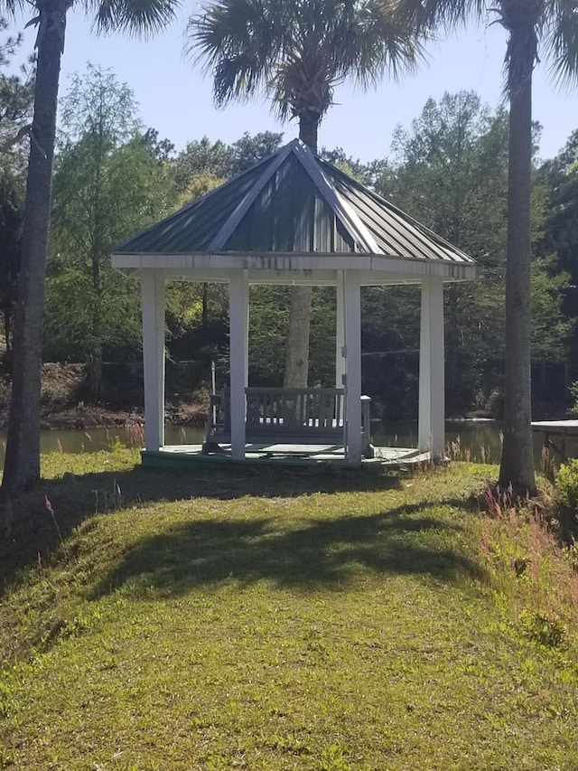 surrounding community featuring a water view, a yard, and a gazebo