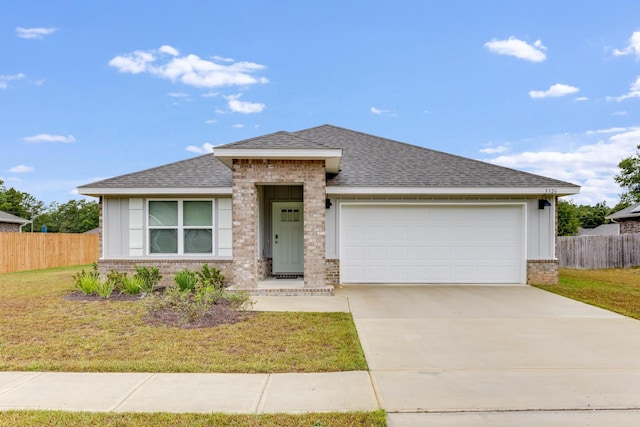 view of front of house featuring a garage and a front yard