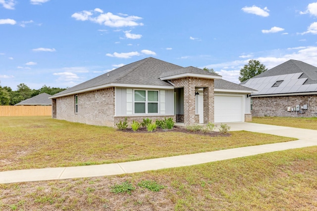 view of front of home featuring a front lawn and a garage