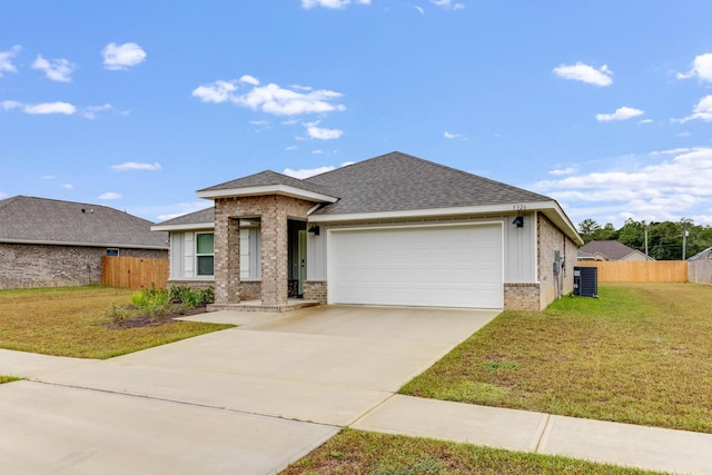 view of front of home featuring central AC unit, a garage, and a front lawn