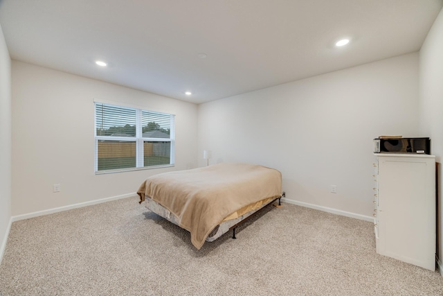 bedroom with light colored carpet