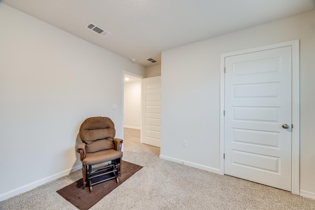 living area featuring light colored carpet