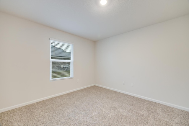 unfurnished room featuring carpet