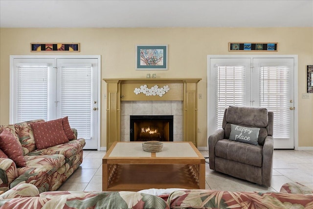 living room with a tiled fireplace and light tile patterned floors