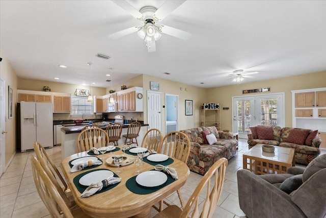 tiled dining room with french doors, ceiling fan, and sink