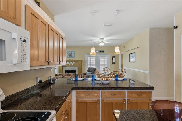 kitchen with a fireplace, decorative light fixtures, range, kitchen peninsula, and ceiling fan