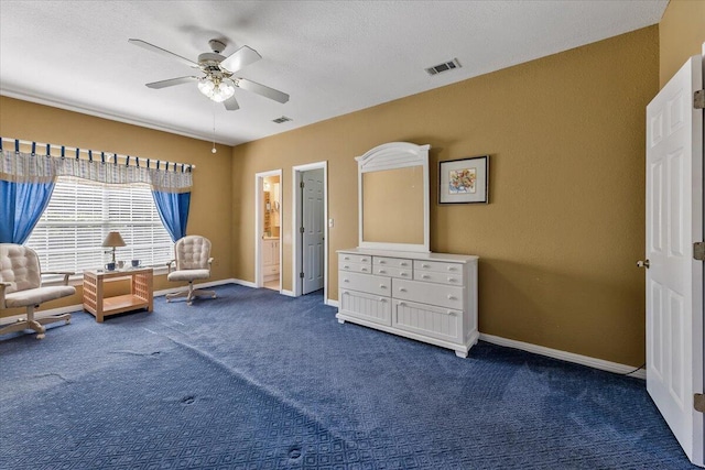 sitting room with a textured ceiling, dark colored carpet, and ceiling fan